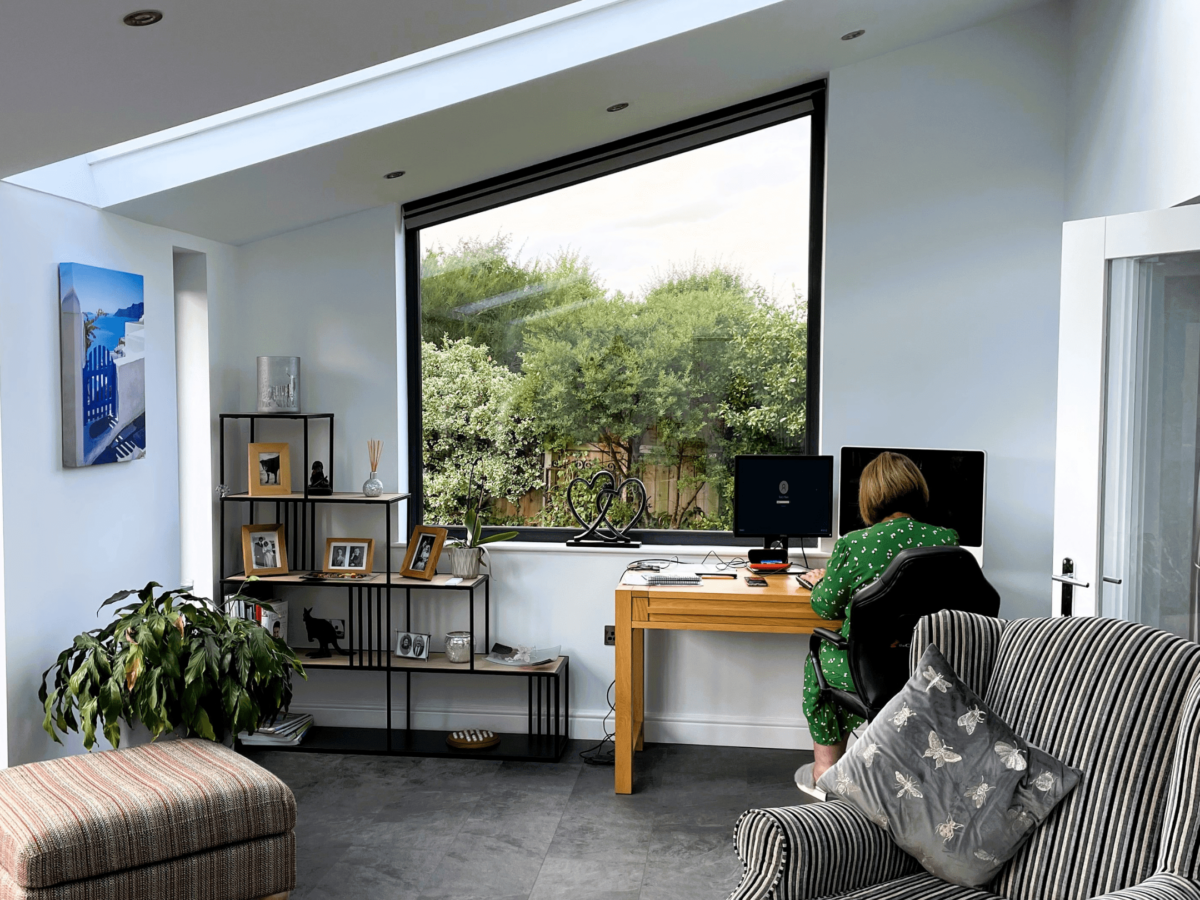 woman working at a desk inside a sloping roof hup! extension