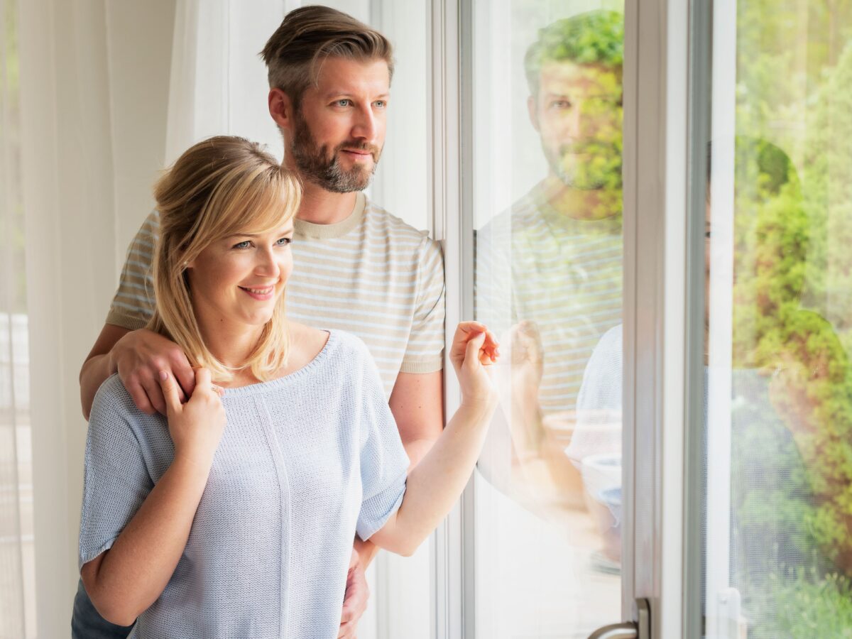 Happy couple with conservatory extension installation