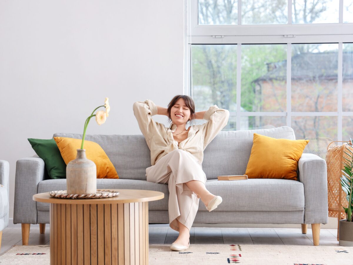 Happy person on sofa with conservatory extension installation
